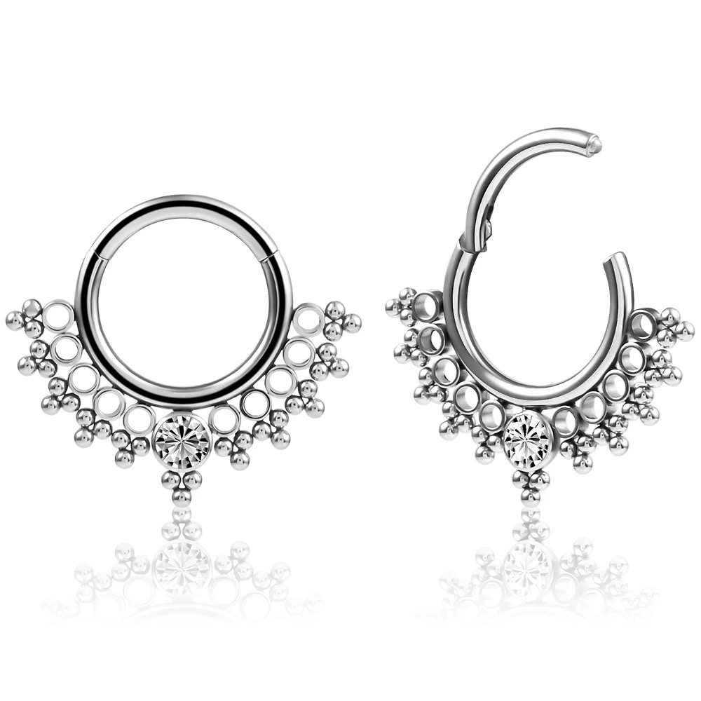 G23 titanium piercing jewelry inlaid with cubic zirconias, including internally threaded and internally toothed ear studs, lip studs, nose studs, and helix ear studs.
