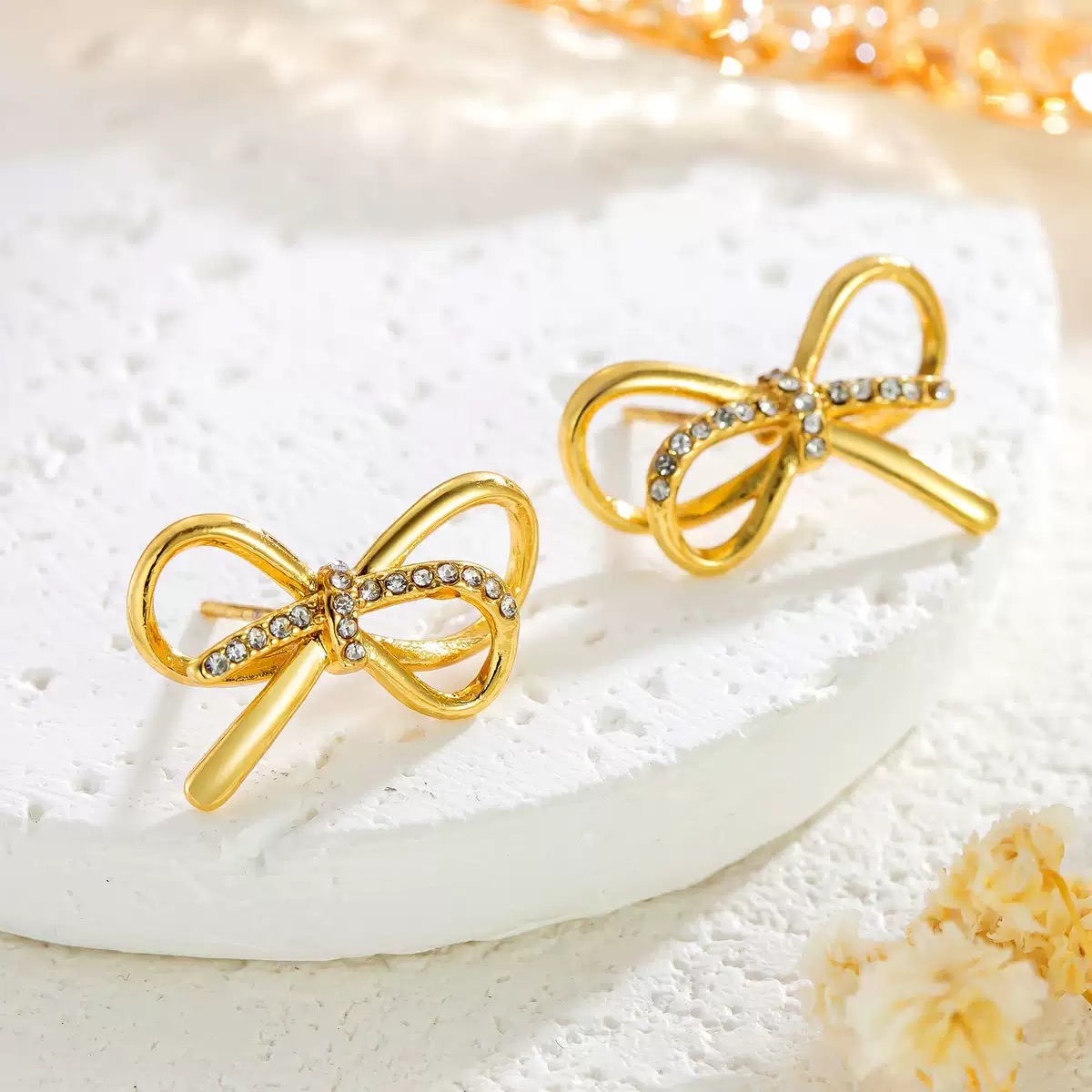 tainless steel bow - shaped stud earrings with diamond inlays