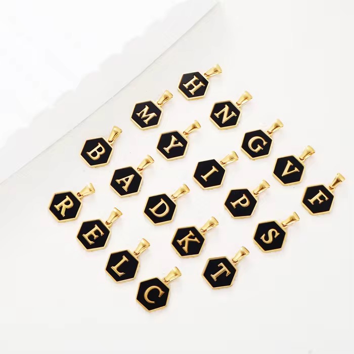 Stainless steel pendant plated with 18K gold in the shape of letters.