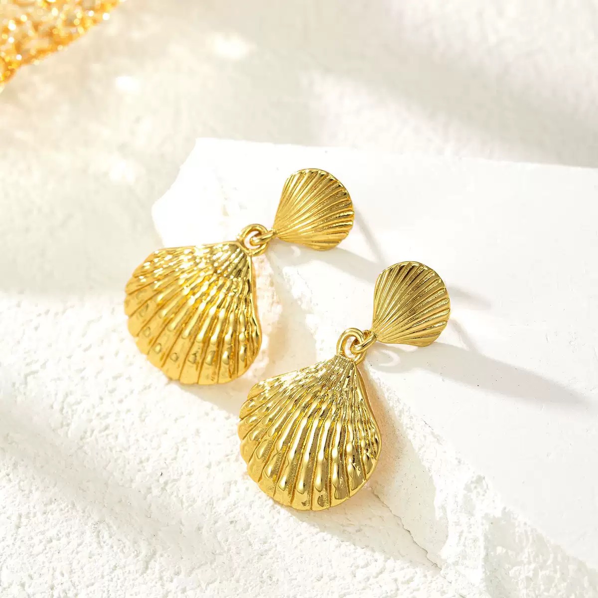 Exaggerated, niche - style stud earrings with a high - end feel. These metal earrings feature a shell - like texture, are electro - plated, and inlaid with mixed diamonds in a heart shape.