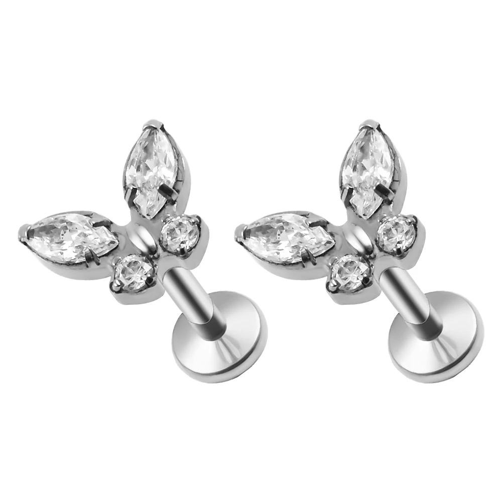 G23 titanium piercing jewelry inlaid with cubic zirconias, including internally threaded and internally toothed ear studs, lip studs, nose studs, and helix ear studs.
